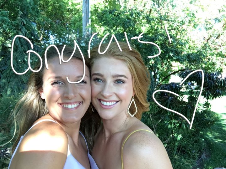 Two women smiling with 'congrats!' written along with a heart.
